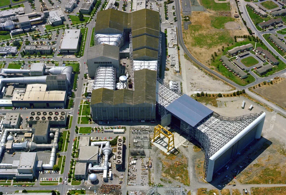 Aerial view of the National Full-Scale Aerodynamics Complex at NASA Ames Research Center, with the open 80- by 120-foot wind tunnel inlet beside the long tunnel buildings