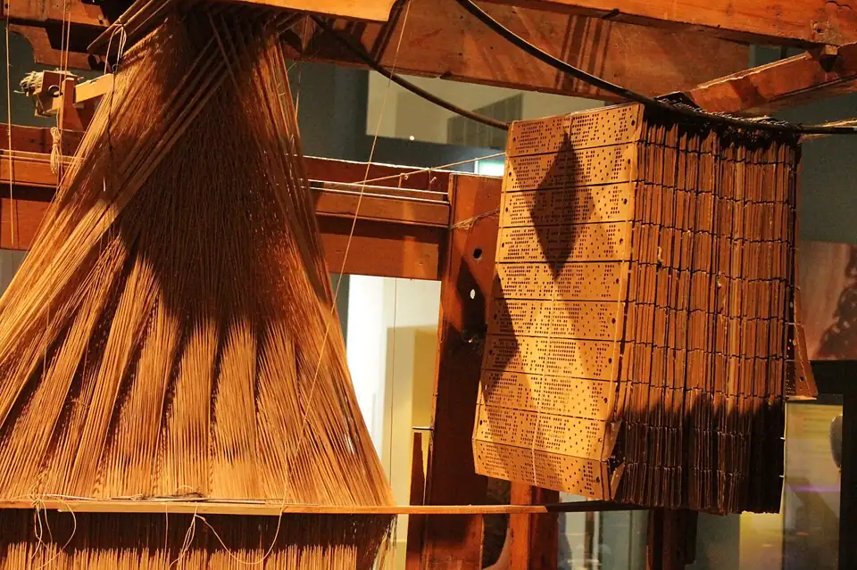 Photo: A Jacquard loom showing information punchcards, National Museum of Scotland