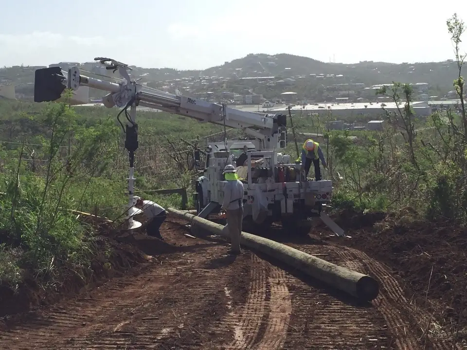Utility crews set a new power pole during restoration work (file photo, U.S. Virgin Islands)