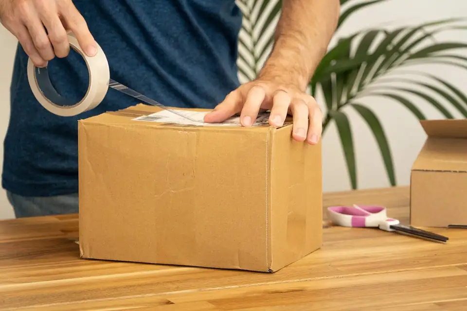 A parcel being taped for shipping
