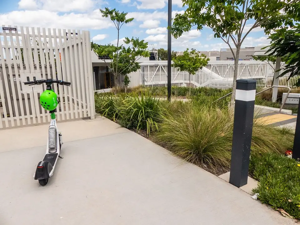 A Lime e-scooter parked at a station entrance (file photo, Australia)