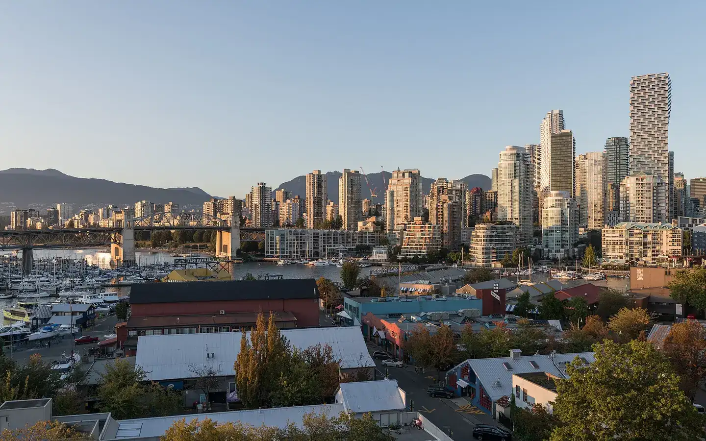 A view of Vancouver Skyline, Granville Island and Burrard St Bridge, as seen from Granville St Bridge at sunset