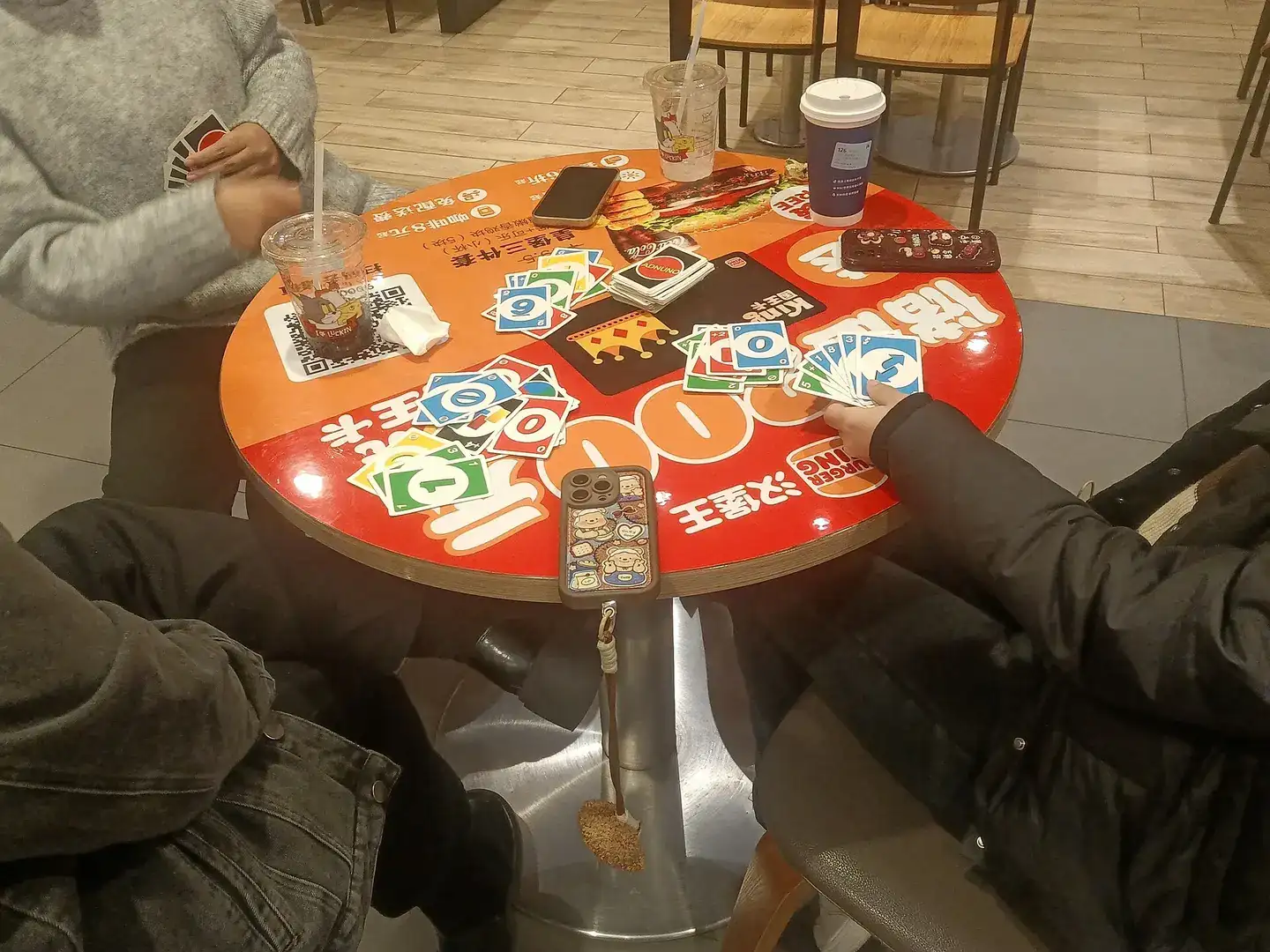 A card game in progress on a round table
