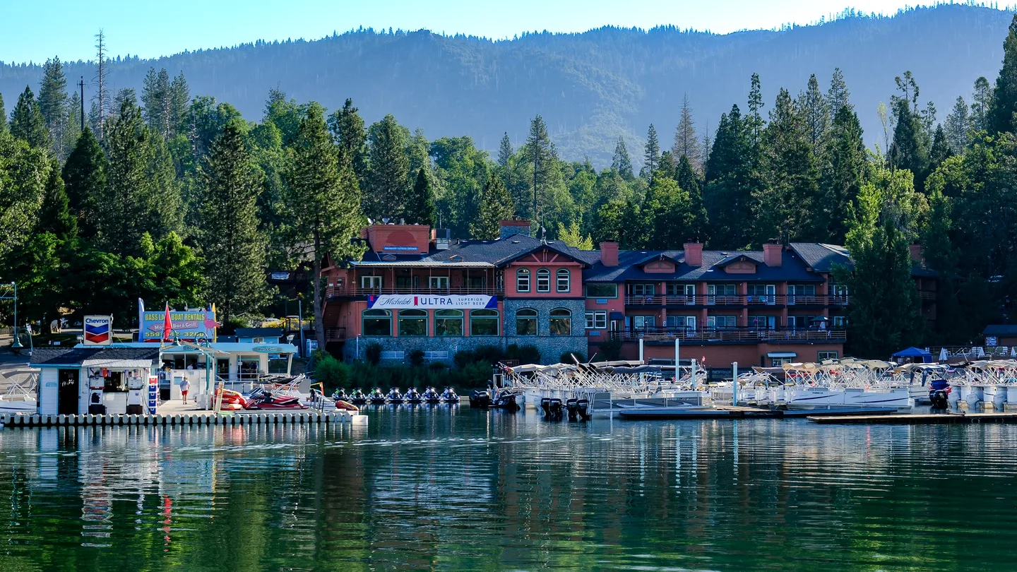 A lakeside mountain lodge framed by evergreen forest